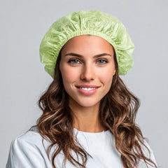 Worker wearing a 65 gsm PLA/PBAT bouffant cap for controlled hygiene support