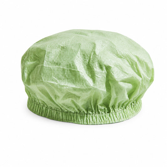 Disposable PLA/PBAT bouffant cap for food-processing hygiene on white background