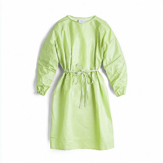 Green disposable gown with adjustable waist ties on white