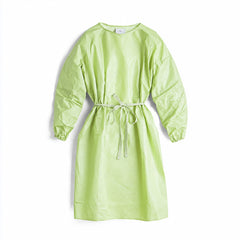 Green disposable gown with adjustable waist ties on white