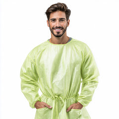 Person wearing green disposable protective gown front view