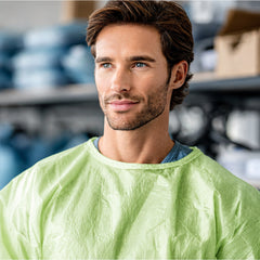 Green isolation gown neckline and sleeve fit close-up