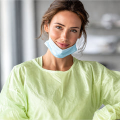 Green disposable gown shown in a controlled facility environment