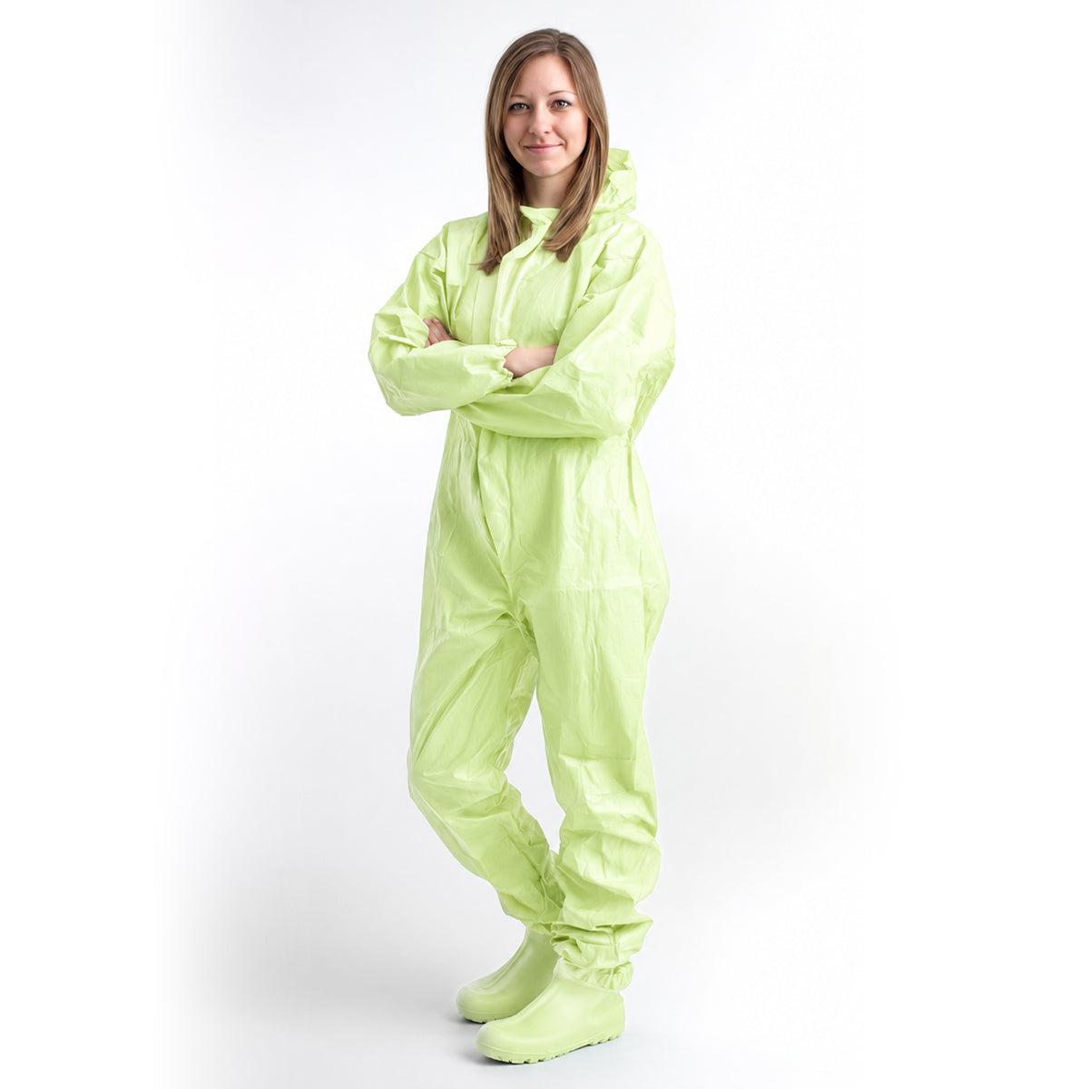 Person wearing green coverall with arms crossed on white