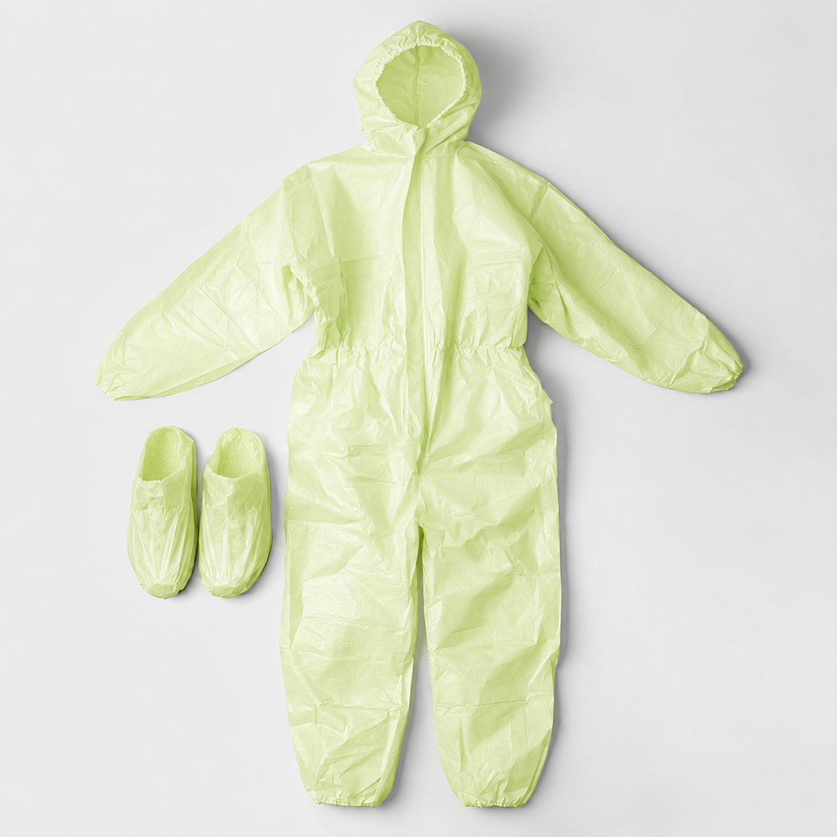Green coverall and matching shoe covers laid flat