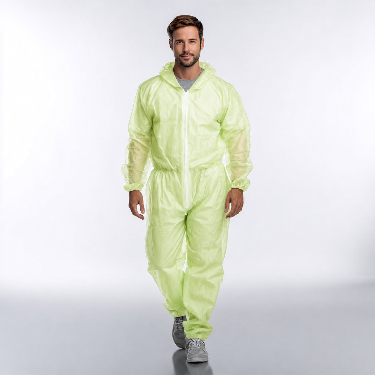 Person wearing green disposable coverall full front view