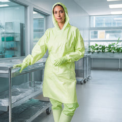 Person wearing green hooded coverall in clean indoor workspace