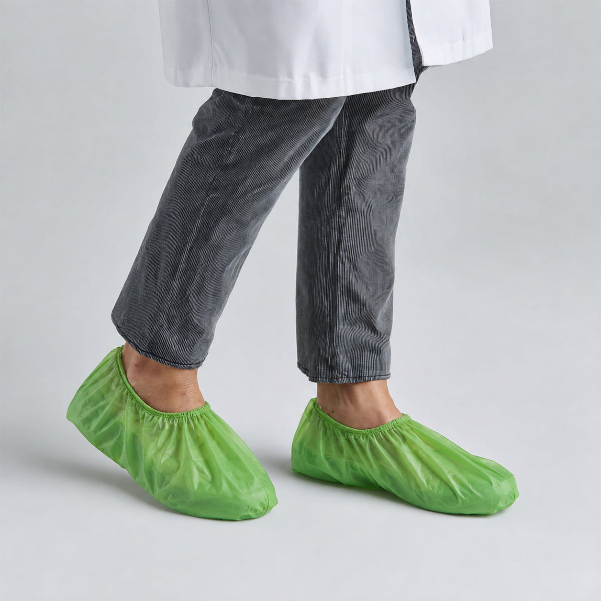 BioRAYGARD green PLA/PBAT shoe covers worn for general hygiene