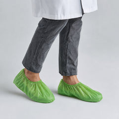 BioRAYGARD green PLA/PBAT shoe covers worn for general hygiene