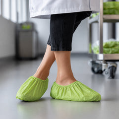 Disposable green shoe covers used in a facility support setting