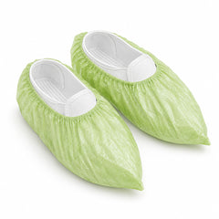 Pair of green disposable shoe covers with elastic openings
