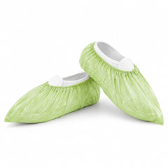 Low-profile green shoe covers on white background