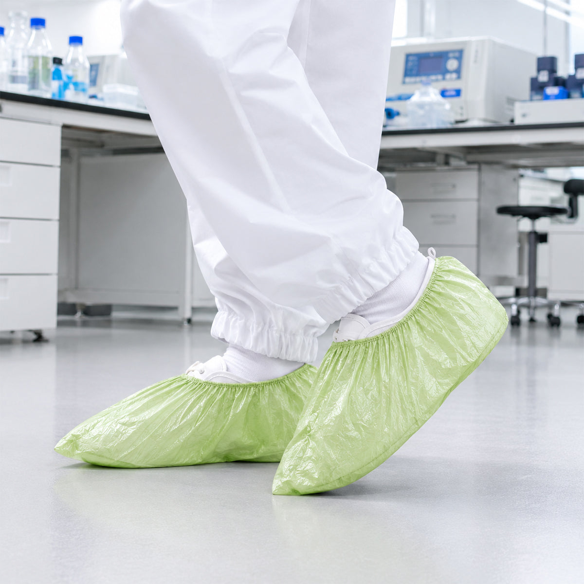 Green shoe covers worn in a laboratory support environment