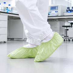Green shoe covers worn in a laboratory support environment