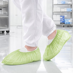 PLA/PBAT shoe covers in a clean indoor workspace