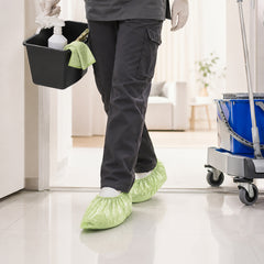 Green disposable shoe covers for cleaning and sanitation support